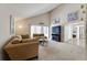 Inviting living room with vaulted ceilings, comfortable couches, and a view of the Primary bedroom at 7412 Bellows Falls Ln, Hudson, FL 34667