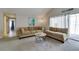 Bright living room with vaulted ceilings, neutral carpet, and sliding glass door at 7412 Bellows Falls Ln, Hudson, FL 34667