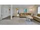 Comfortable living room with neutral tones, cozy seating, and access to a hallway at 7412 Bellows Falls Ln, Hudson, FL 34667