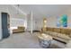 Living room with high ceilings, neutral carpet, a lounge chair and a large comfortable sofa at 7412 Bellows Falls Ln, Hudson, FL 34667