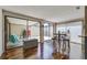 Open living area with wood floors, sliders to patio, and table with stools in dining area at 7412 Bellows Falls Ln, Hudson, FL 34667
