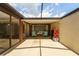 Sun-drenched patio with glass roof, ample seating, and open layout, ideal for outdoor living and entertaining at 7412 Bellows Falls Ln, Hudson, FL 34667