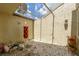 Covered patio area featuring a gravel floor, a stacked terracotta planter, and open sky at 7412 Bellows Falls Ln, Hudson, FL 34667
