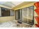 Enclosed patio with gravel floor, open roof, and view to living area with sliding glass doors at 7412 Bellows Falls Ln, Hudson, FL 34667