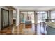 Light-filled sun room featuring sliding glass doors and hardwood floors at 7412 Bellows Falls Ln, Hudson, FL 34667