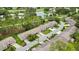 Aerial view of townhomes, golf course, and a community lake at 7423 Woodhollow Rd, Spring Hill, FL 34606