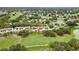 Aerial view of townhomes in community surrounded by golf course at 7423 Woodhollow Rd, Spring Hill, FL 34606