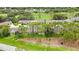Aerial view of a residential community with lush landscaping and golf course, showcasing the serene surroundings at 7423 Woodhollow Rd, Spring Hill, FL 34606