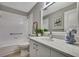 Bathroom with tub/shower combo, elegant vanity, and framed mirror at 7423 Woodhollow Rd, Spring Hill, FL 34606