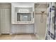 Bathroom features a dual-sink vanity, tiled shower, and linen closet at 7423 Woodhollow Rd, Spring Hill, FL 34606
