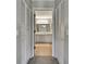 Dual sinks in the bathroom, tile floor, and louvered doors at 7423 Woodhollow Rd, Spring Hill, FL 34606