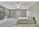 Spacious main bedroom with carpet, ceiling fan, and sliding glass doors to the exterior at 7423 Woodhollow Rd, Spring Hill, FL 34606
