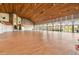 Expansive event space with wood floors, high ceilings, arched windows, and a cozy fireplace at 7423 Woodhollow Rd, Spring Hill, FL 34606