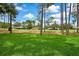 Expansive, well-manicured front lawn surrounded by mature trees, offering a serene and inviting landscape at 7423 Woodhollow Rd, Spring Hill, FL 34606