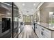 Modern kitchen boasts white cabinets, granite countertops, stainless steel appliances, and wood-look flooring at 7423 Woodhollow Rd, Spring Hill, FL 34606