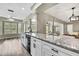 Bright kitchen featuring granite countertops, stainless steel appliances, and white cabinetry at 7423 Woodhollow Rd, Spring Hill, FL 34606