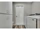 Laundry room with front load washer/dryer and storage cabinets at 7423 Woodhollow Rd, Spring Hill, FL 34606