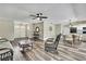 Bright living area with hardwood flooring, light-colored walls, and stylish furnishings perfect for relaxing and entertaining at 7423 Woodhollow Rd, Spring Hill, FL 34606
