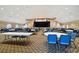 Spacious meeting hall with ample seating, stage, and patterned carpeting at 7423 Woodhollow Rd, Spring Hill, FL 34606