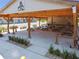 Spacious outdoor pavilion with picnic tables, a grill, and comfortable gathering spots for community members at 7423 Woodhollow Rd, Spring Hill, FL 34606