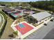 Aerial view of the Timber Pines recreation area featuring pickleball courts, a basketball court, and covered seating at 7423 Woodhollow Rd, Spring Hill, FL 34606