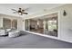 Cozy sunroom with comfortable seating, sliding glass doors, and view of the backyard at 7423 Woodhollow Rd, Spring Hill, FL 34606