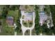 Aerial view of houses with pools, landscaping, and driveways surrounded by trees at 7550 Jomel Dr, Weeki Wachee, FL 34607