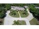 Aerial view of home with circular driveway, mature landscaping, and detached garage at 7550 Jomel Dr, Weeki Wachee, FL 34607