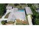 Birds eye view of home with pool, large yard, mature trees and detached garage at 7550 Jomel Dr, Weeki Wachee, FL 34607