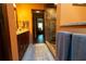 Well-lit bathroom features a wood vanity, granite countertop, large shower, and decorative rug at 7550 Jomel Dr, Weeki Wachee, FL 34607