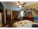 Spacious bedroom boasts wood floors, a ceiling fan, and ample storage with a closet at 7550 Jomel Dr, Weeki Wachee, FL 34607