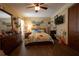 Bright bedroom featuring wood floors, ample natural light, and a comfortable floral quilt at 7550 Jomel Dr, Weeki Wachee, FL 34607