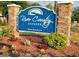 Decorative community sign reading 'River Country Estates' with colorful landscaping at 7550 Jomel Dr, Weeki Wachee, FL 34607
