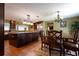 Open kitchen and dining area with wood floors, a large island, stainless appliances, and dark wood cabinets at 7550 Jomel Dr, Weeki Wachee, FL 34607