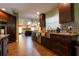 Gourmet kitchen featuring dark wood cabinetry, stainless steel appliances, and an open layout to the Gathering room at 7550 Jomel Dr, Weeki Wachee, FL 34607
