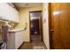 Functional laundry room with sink, storage cabinets, and easy access to other areas of the home at 7550 Jomel Dr, Weeki Wachee, FL 34607