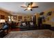 Casual living room featuring wood flooring, a ceiling fan, and an open layout to the dining area at 7550 Jomel Dr, Weeki Wachee, FL 34607