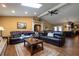 Comfortable living room featuring a skylight, wood flooring, and a large leather sectional sofa at 7550 Jomel Dr, Weeki Wachee, FL 34607