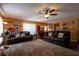 Comfortable living room featuring a ceiling fan, wood flooring, and a large rug at 7550 Jomel Dr, Weeki Wachee, FL 34607