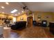 Open-concept living room featuring vaulted ceilings, wood floors, and a stone fireplace at 7550 Jomel Dr, Weeki Wachee, FL 34607