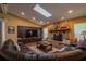 Cozy living room with a stone fireplace, built-in cabinetry, and ample natural light from a skylight at 7550 Jomel Dr, Weeki Wachee, FL 34607