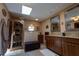 Bright main bathroom with dual sinks, granite countertops, a sauna, and a skylight at 7550 Jomel Dr, Weeki Wachee, FL 34607