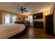 Spacious main bedroom featuring wood floors, ceiling fan, and a sliding door to the lanai at 7550 Jomel Dr, Weeki Wachee, FL 34607