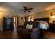 Comfortable main bedroom with wood floors, a seating area, and decorative wall art at 7550 Jomel Dr, Weeki Wachee, FL 34607