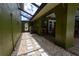 Charming patio with stone pavers, gravel, and a sun-covered walkway to the home's interior at 7550 Jomel Dr, Weeki Wachee, FL 34607