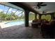 View of the screened-in pool area from the covered lanai, perfect for outdoor living at 7550 Jomel Dr, Weeki Wachee, FL 34607