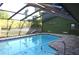 Enjoy this backyard with a screened-in pool area and mature landscaping for privacy at 7550 Jomel Dr, Weeki Wachee, FL 34607