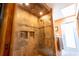This tiled shower features dual shower heads, a built-in soap dish, and a glass door at 7550 Jomel Dr, Weeki Wachee, FL 34607