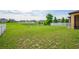 An expansive backyard with a pond and lush green grass, perfect for outdoor activities at 758 Alpine Thistle Dr, Brooksville, FL 34604