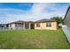 Lovely backyard with a well-maintained lawn, white fencing, and a cozy screened-in lanai at 758 Alpine Thistle Dr, Brooksville, FL 34604